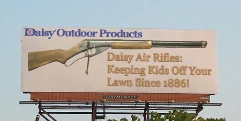 Billboard advertisement for: Daisy Air Rifles - Keeping kids off your lawn since 1886.