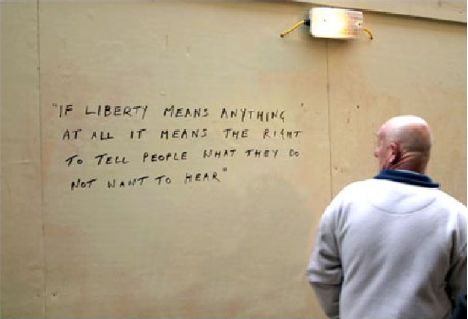 Photo of wall with the following words: If Liberty means anything at all, it means the right to tell people what they do not want to hear.