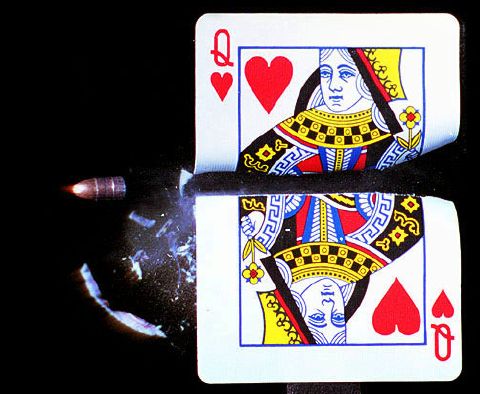 Moment of impact, bullet passing through queen of hearts