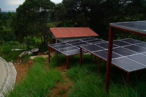 Solar panels in front of powerhouse at Rancho de Caldera