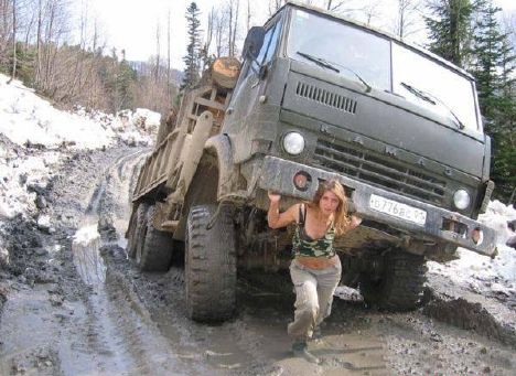 Woman pulls army truck out of Siberian mud